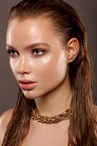 Beautiful brunette woman with slicked-back, wet-look hair